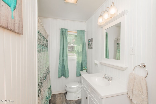 bathroom with vanity, hardwood / wood-style floors, walk in shower, crown molding, and toilet