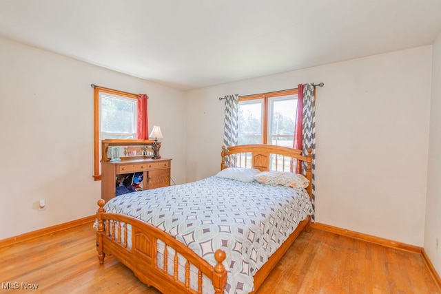 bedroom with wood-type flooring