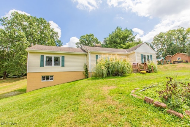 exterior space with a deck and a lawn