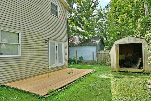 view of yard featuring a wooden deck and a shed