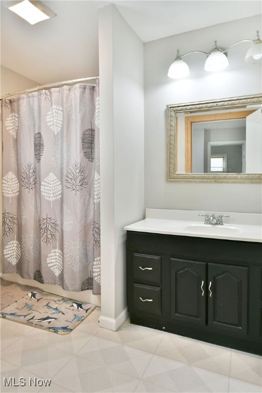 bathroom with vanity and curtained shower