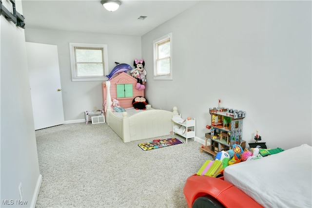 bedroom with carpet flooring and multiple windows