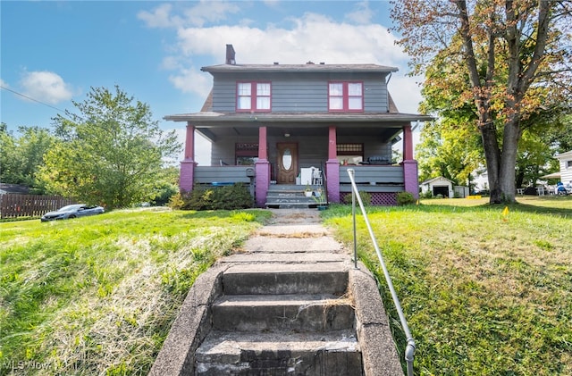 bungalow featuring a front lawn and a porch