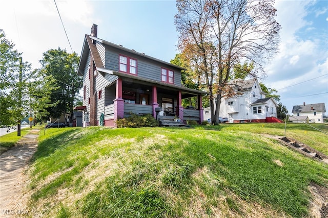 view of front of home featuring a porch and a front yard