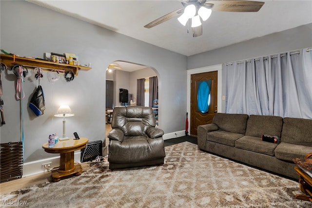 living room featuring hardwood / wood-style floors and ceiling fan