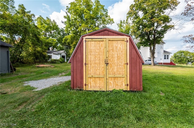 view of outbuilding with a yard