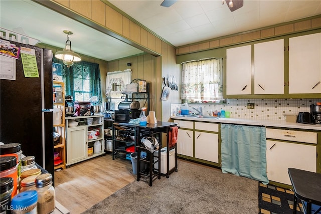 kitchen with pendant lighting, a healthy amount of sunlight, ceiling fan, and light hardwood / wood-style floors