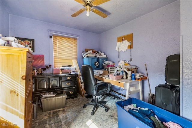 office area with a textured ceiling, ceiling fan, and carpet flooring