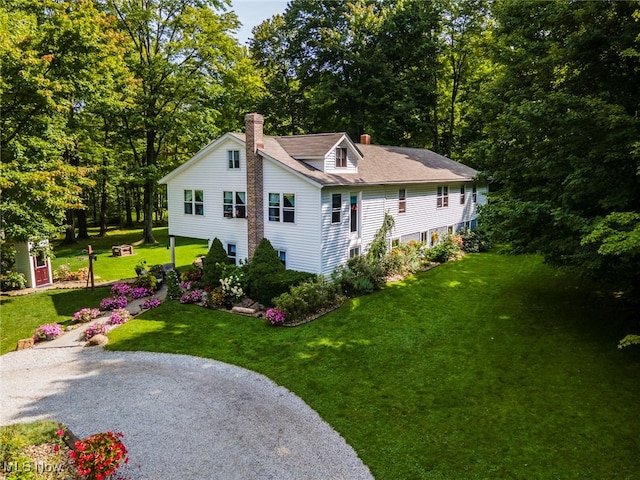 view of property exterior with a lawn