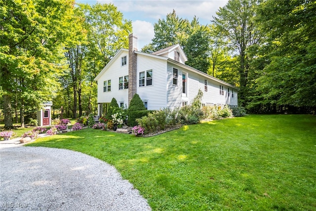 view of property exterior with a yard