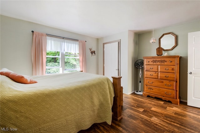 bedroom with dark hardwood / wood-style floors