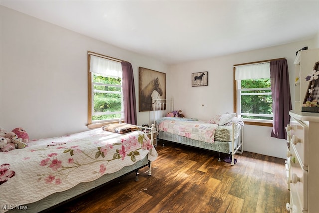 bedroom with dark wood-type flooring