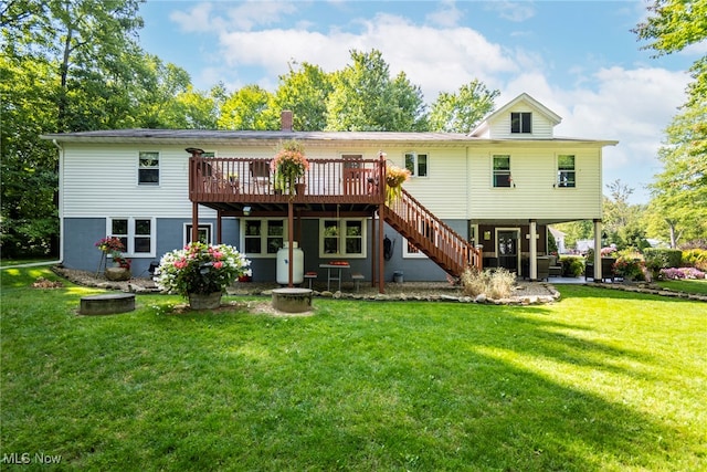 rear view of house with a yard and a deck