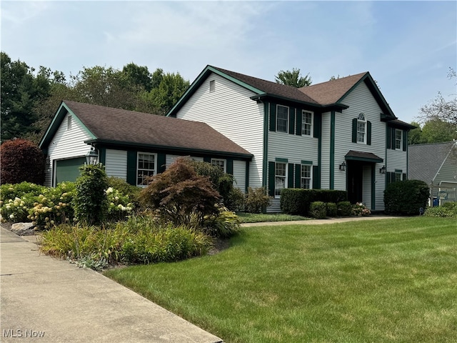 colonial inspired home featuring a front lawn and a garage