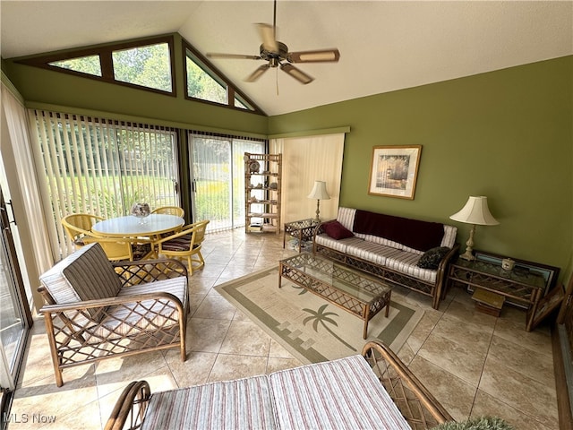 living room featuring lofted ceiling, ceiling fan, and light tile patterned floors