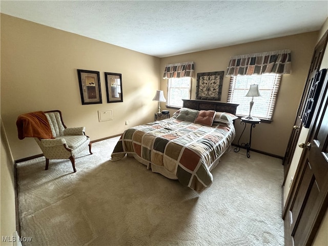 bedroom featuring a textured ceiling and carpet