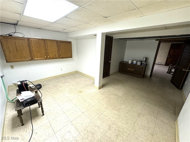 interior space with a paneled ceiling