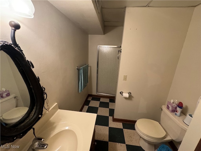 bathroom featuring vanity, toilet, and walk in shower