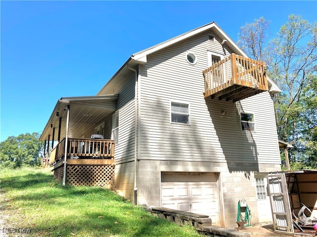 rear view of house featuring a yard and a garage