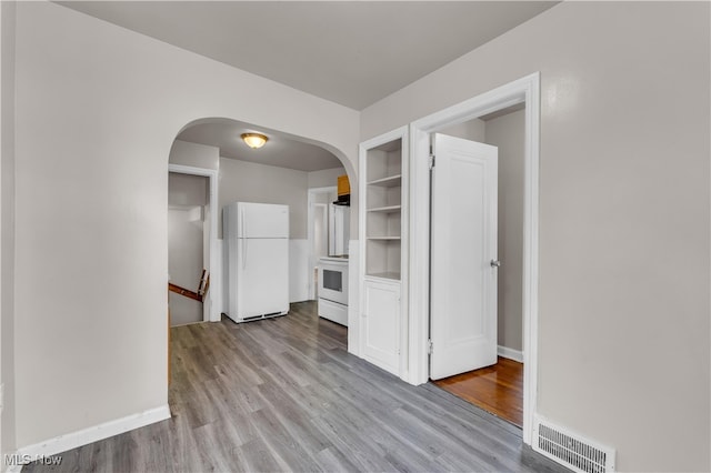 unfurnished room with light wood-type flooring