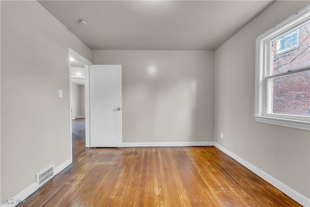 spare room featuring wood-type flooring