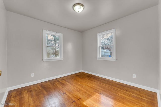 unfurnished room with wood-type flooring