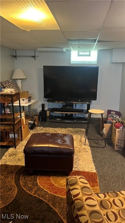 living room featuring a paneled ceiling