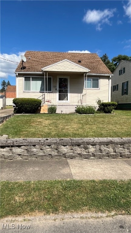 view of front of house with covered porch and a front yard