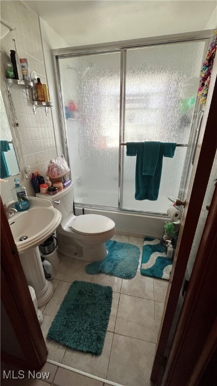 bathroom with toilet and tile patterned floors