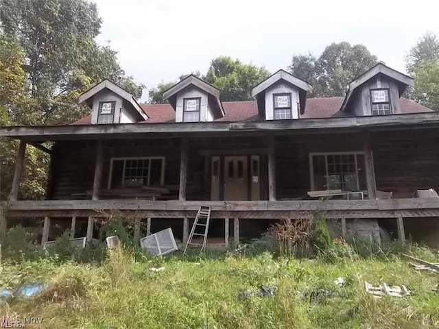 rear view of property featuring a porch