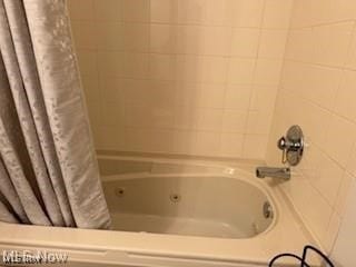 bathroom with shower / bathtub combination with curtain