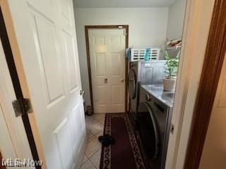 laundry area featuring independent washer and dryer and tile patterned flooring