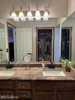 620 Bridgeview Ave, Chester, WV 26034 - bathroom featuring double vanity, a chandelier, and a walk in closet