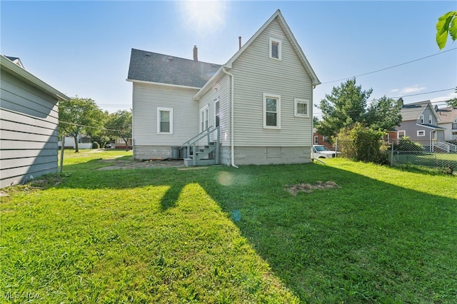 rear view of house with a yard