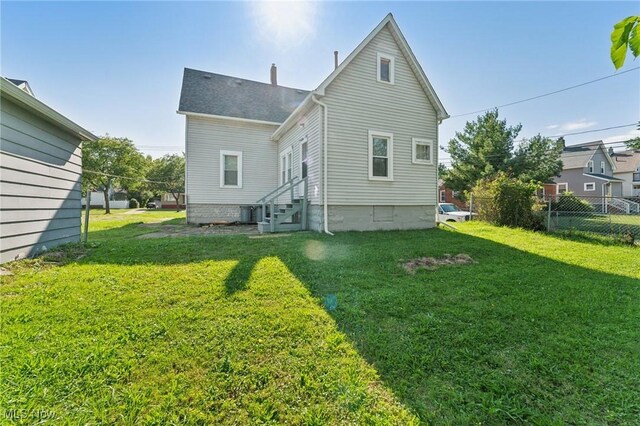 14631 Granger Rd, Maple Heights, OH 44137 - back of property featuring entry steps, a yard, a chimney, and fence