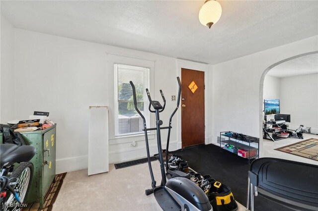 14631 Granger Rd, Maple Heights, OH 44137 - workout room with carpet, a textured ceiling, arched walkways, and baseboards