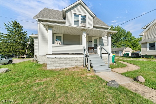 bungalow-style home featuring a front yard and covered porch