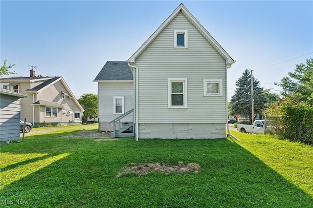 rear view of house with a yard