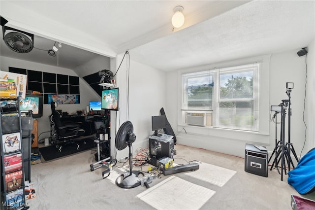 exercise room featuring lofted ceiling, light colored carpet, cooling unit, and a textured ceiling