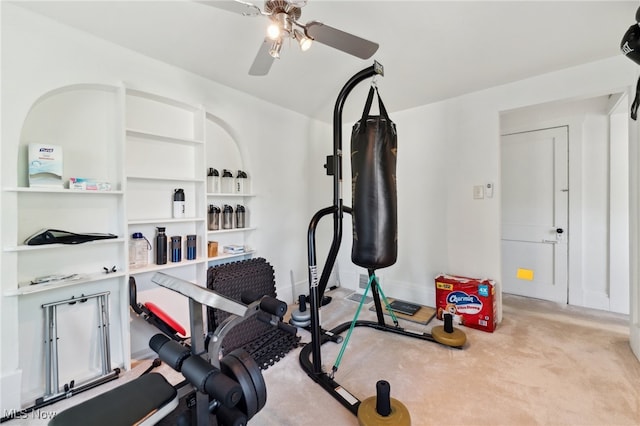 workout area featuring light carpet and ceiling fan