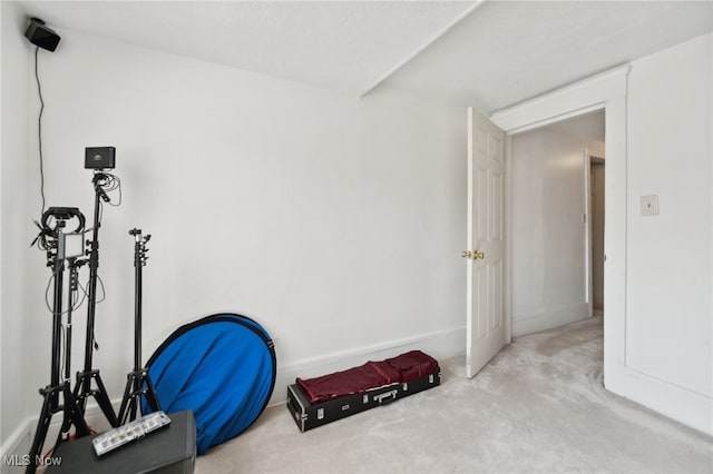 workout room with light colored carpet