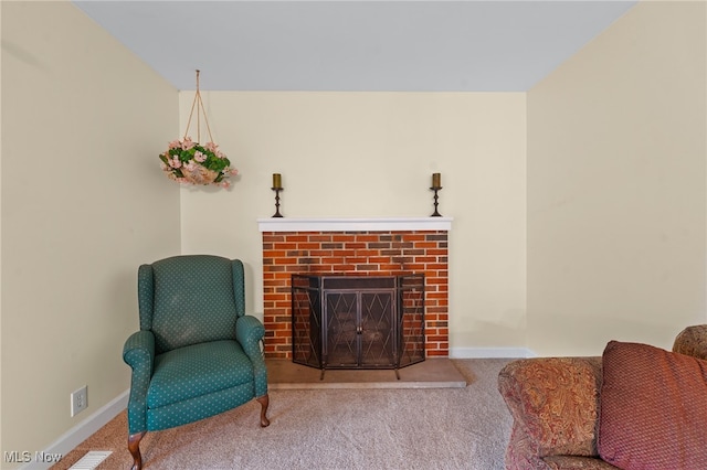 living area featuring carpet flooring and a fireplace