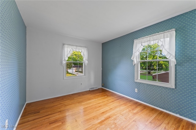 spare room with light hardwood / wood-style floors