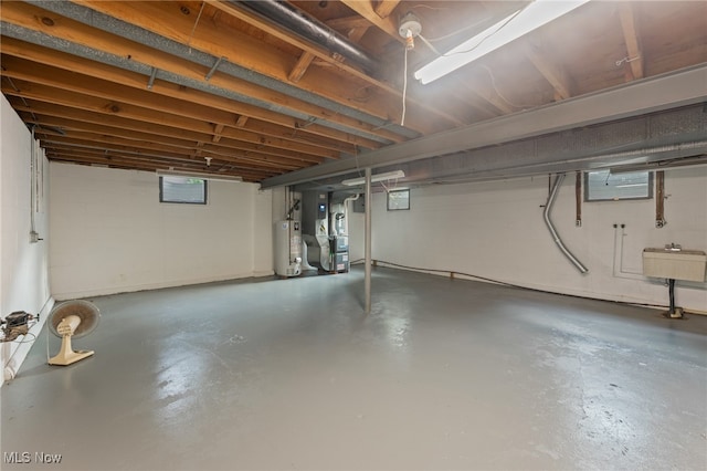 basement featuring heating unit and water heater