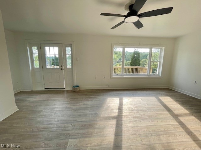 interior space with light hardwood / wood-style floors and ceiling fan