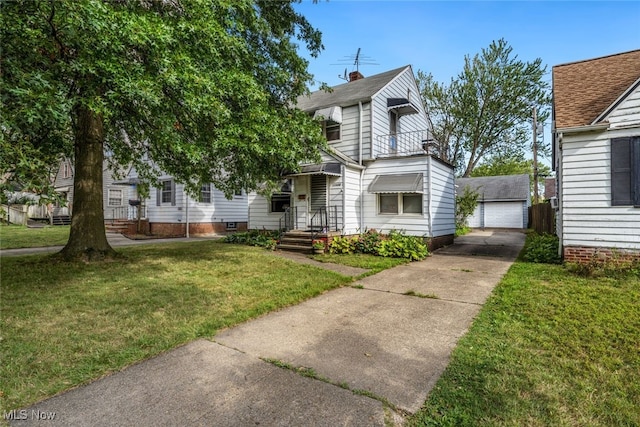 view of front of property featuring a garage, an outdoor structure, and a front yard