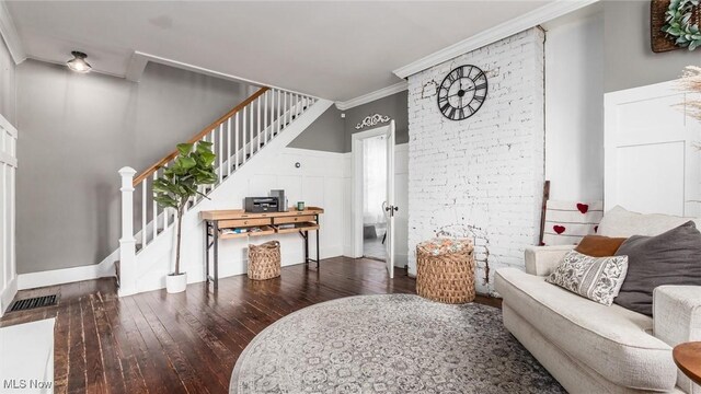 living room featuring crown molding and dark hardwood / wood-style flooring