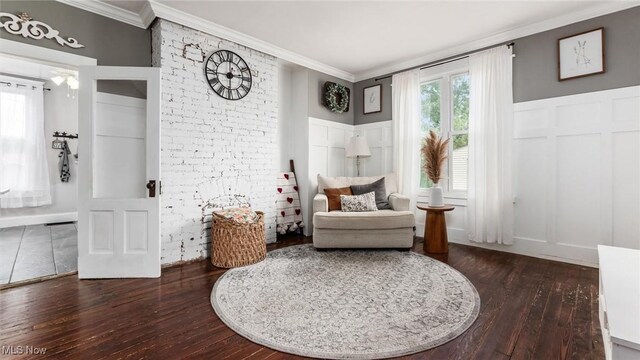 sitting room featuring ornamental molding and dark hardwood / wood-style flooring