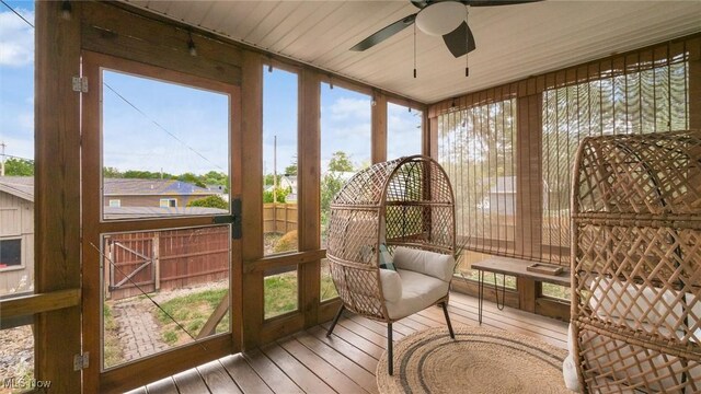 sunroom featuring ceiling fan