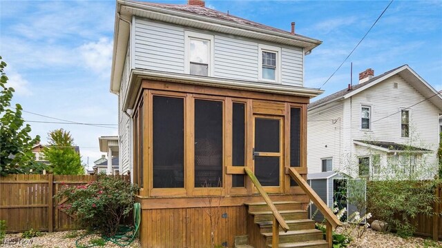 back of house featuring a sunroom